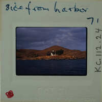 This is a photograph of a scenic harbor with a small island and buildings, taken on October 7th, 1962.