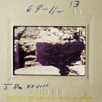 Two vintage photos depicting stone ruins and construction sites, possibly from an archaeological expedition.