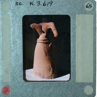 Headless terracotta statue from the front.