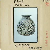 Decorative vase with swirling patterns on an antique postcard.