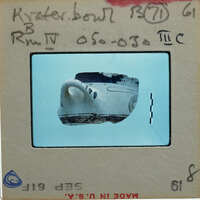 Fragment of decorated krater bowl showing rim and one handle.