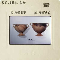 Two ancient Greek vases displayed on a white surface.