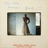 Small clay figurine on display.