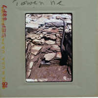 A photograph of a stone structure with visible damage, possibly from an explosion or natural disaster.