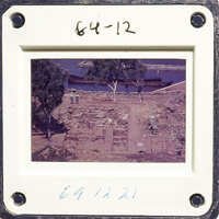 A photograph showing an excavation site with ruins and trees, taken from above.