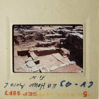 This photo shows an archaeological site with stone ruins, taken from a high angle.