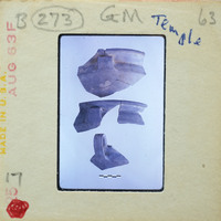 Picture of pottery fragments with labels, possibly from a museum or archaeological site.