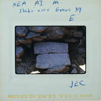 A close-up photograph of a rock formation with handwritten notes on the border.