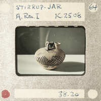 An antique vase displayed on a table with a price tag attached to it.