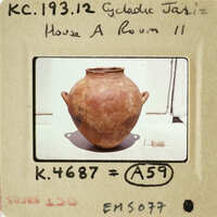 Old clay vase with worn surface on display.