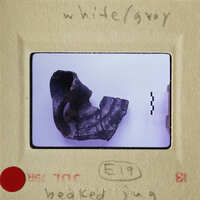 Ancient artifact, possibly an earring, with visible wear and tear.