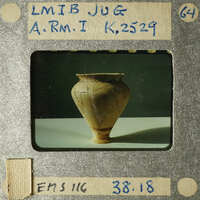 A photograph of an ancient clay pot with visible cracks and imperfections.