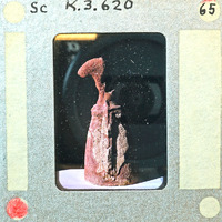 Rear view of terracotta figurine showing torso and skirt K3.620.