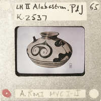 A black and white image of a vase with an intricate design on it.