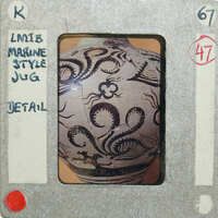 Detailed view of a jug with intricate designs of tentacles.