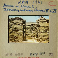 Ancient stone ruins with open doorways and walls.