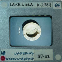 Reassembled bowl of lamp from top showing letters carved in rim, K.2484.