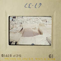 This is an image of two photos, one showing a stone structure and the other a muddy area with a man walking.