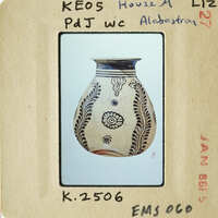 Ancient Greek vase with floral designs on display.