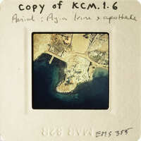 Aerial view of an island with buildings and water.