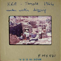 Archaeological site with workers excavating under water.