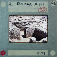 Photo of an old stone structure with a room number and date stamp on it.