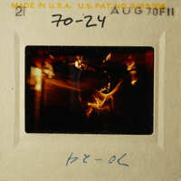 A black and white photograph of an older style film strip with a photo on it, featuring a blurry image of a candlelit scene.