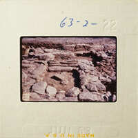 Old stone ruins with vegetation, captured on an antique photographic film strip.