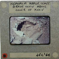 Slide showing semi-circular ring of stones indicating a grave site.