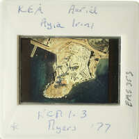 Aerial photograph of an island with buildings and water, dated 1977.