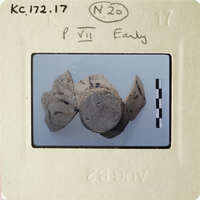 Old photograph of ancient pottery with markings on a white background.