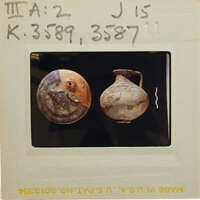 Reassembled stirrup jar on left and jug on right on black background, K.3598 K.3587.