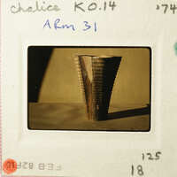 Photograph of an ancient artifact, possibly a cup or bowl with intricate designs and patterns.