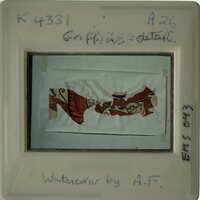 The image shows an ancient artifact with intricate designs, possibly a piece of pottery or textile, displayed against a white background.