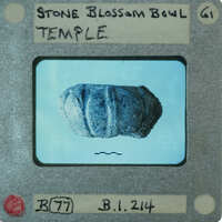 Image of a Stone Blossom Bowl Temple with an item inside, possibly a seed or artifact, on a card with numbers and text annotations.