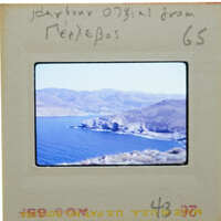 Picture of a scenic landscape with mountains, water, and greenery on an old photo strip.