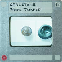 Circular stone object on left with carvings, seal impression on right.