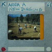 A vintage photograph of men working on a field, with an overlaid label indicating it's from a new digging area.