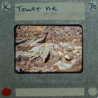 An old film strip with a picture of rocks and dirt on it.