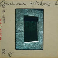 Photo of a window with an image of the moon visible through it, on a vintage film strip.