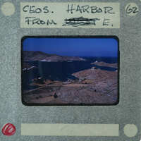 A vintage film strip with a scenic view of an island and ocean.