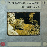 Detail of stone walls forming a doorway with water forming puddles at the bottom