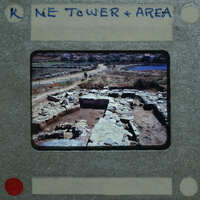 An old photograph of a historical site with ruins and a label indicating it is from the Ne Tower & Area.