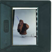 Terracotta figurine torso from side.