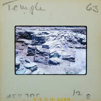 Details of temple stone wall with doorway on the lower left.