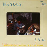 A man working on pottery at a wheel, captured in an old photograph with handwritten details and postage marks.