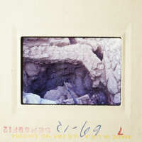 This is an image of a cave entrance with a small tunnel leading into it.