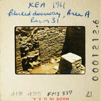 Old photograph of an archaeological site with stone ruins, possibly from ancient times.