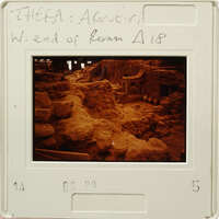 Archaeological ruins with ancient stone structures and rubble, as seen on a slide film.