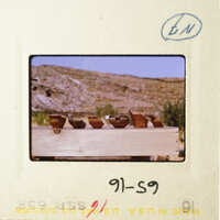 A vintage photo of pottery displayed on a wooden table.